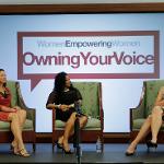 Pannel of three women, seated on stage for the Woman Empowering Women event, speaking on the topic of "Owning Your Voice".