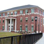 Exterior photo of Roy Richards Sr. Hall from across the pedestrian bridge, towards front campus drive. 