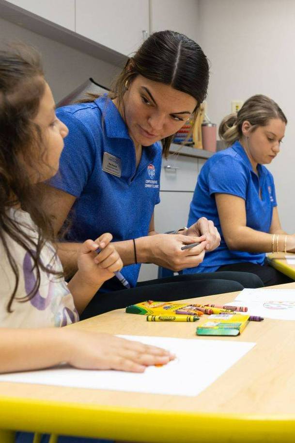 Clinic students working with elementary aged children