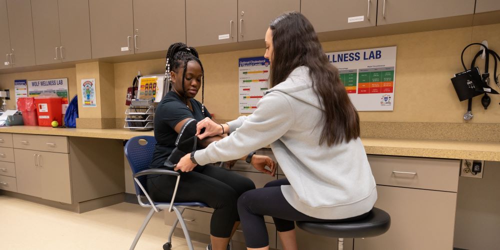Student taking another student's blood pressure