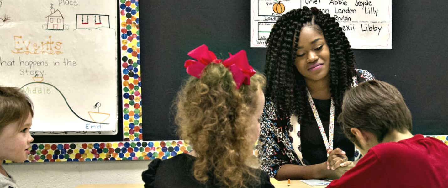 Elementary teacher working with a small group of students.