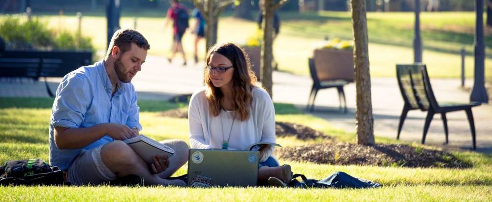 Students sitting in grass.