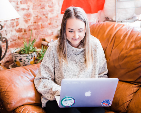 Student on her laptop while sitting on a couch