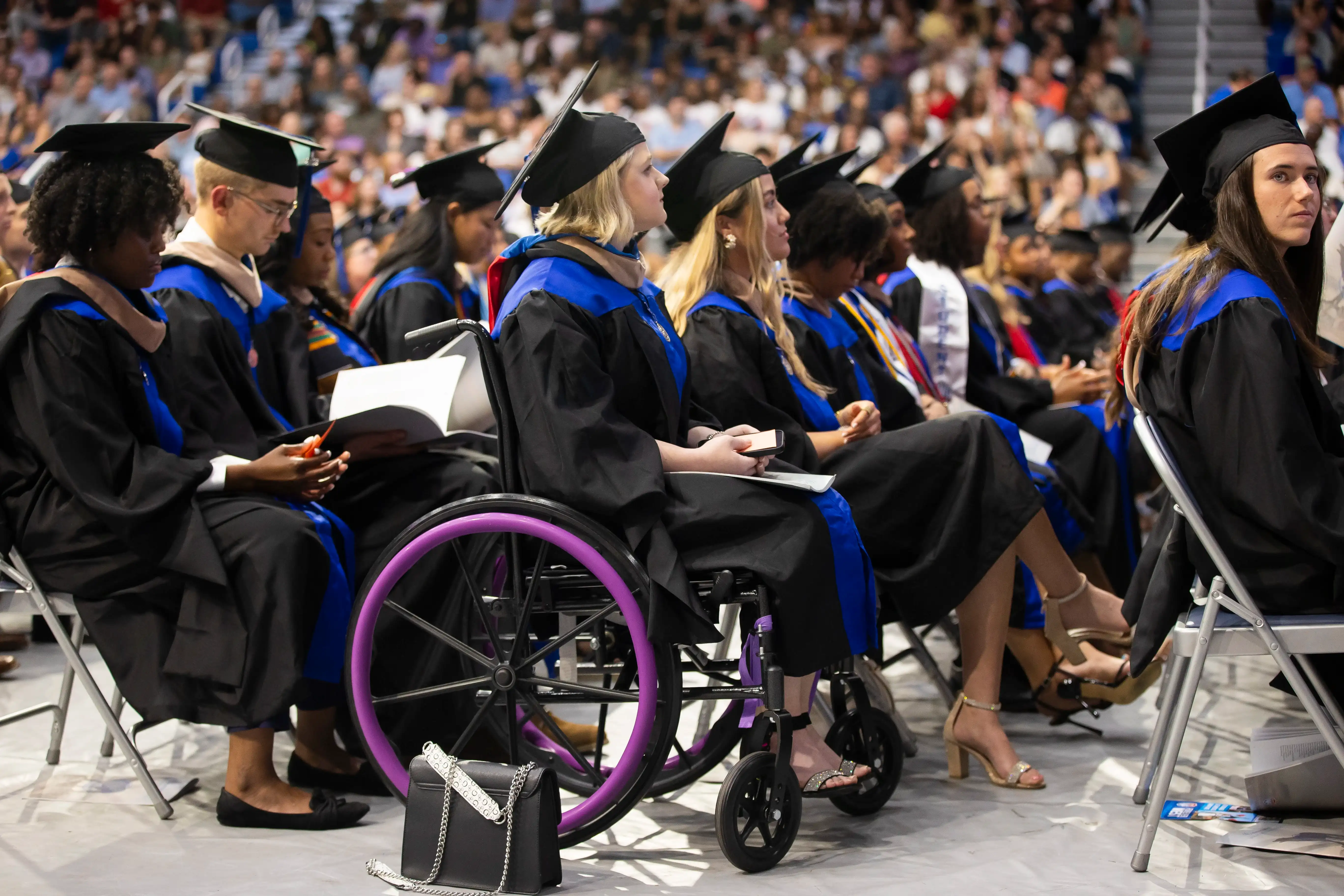 student sitting in wheelchair at graduation ceremony