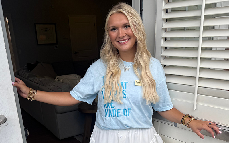 UWG student smiling in front of building on-campus