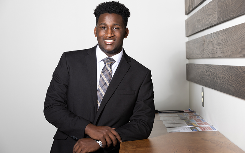 UWG student smiling at desk