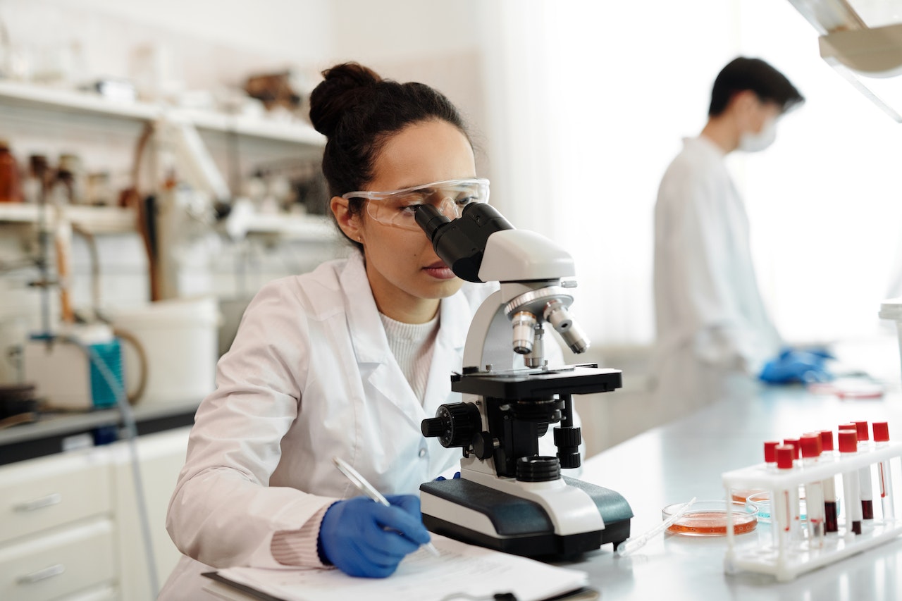 Woman looking through a microscope