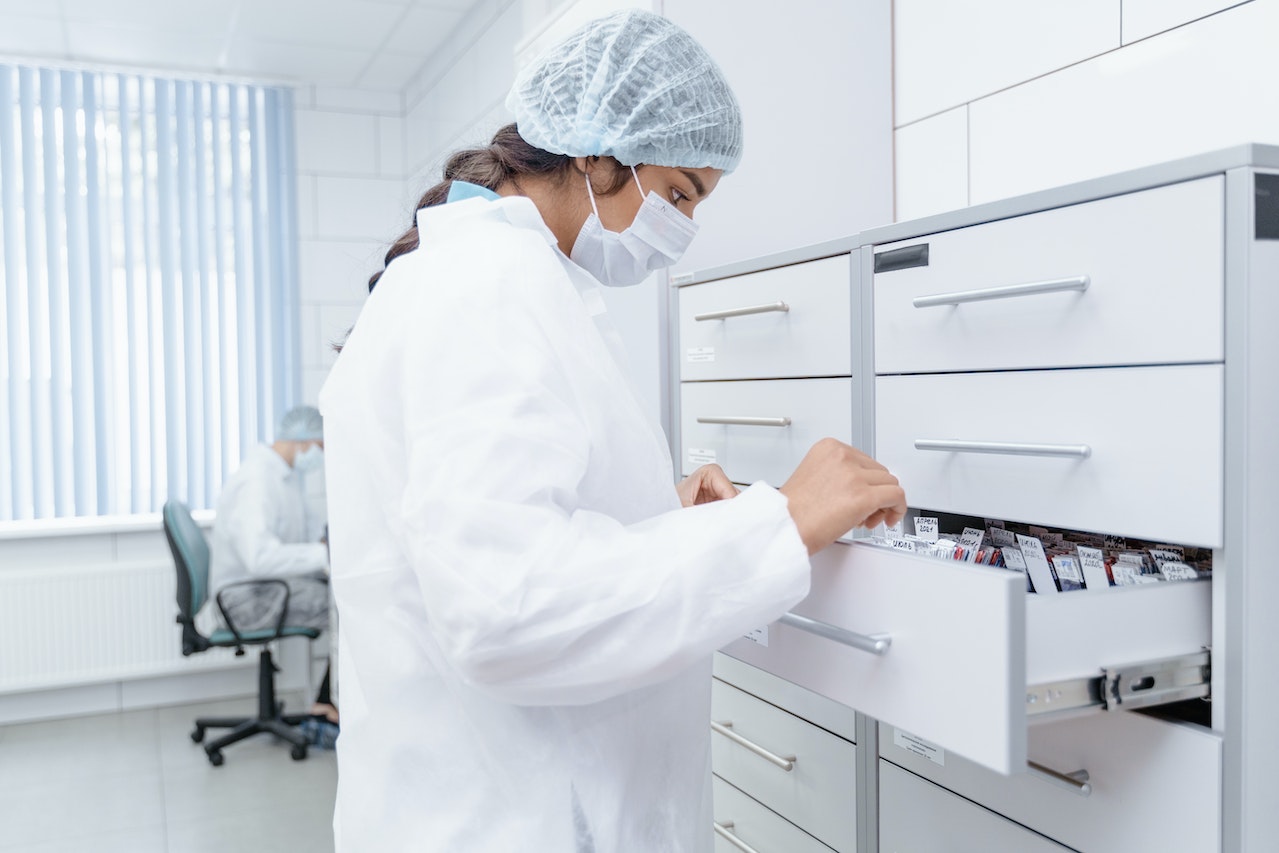 Medical Professional looking at Archives on a Drawer