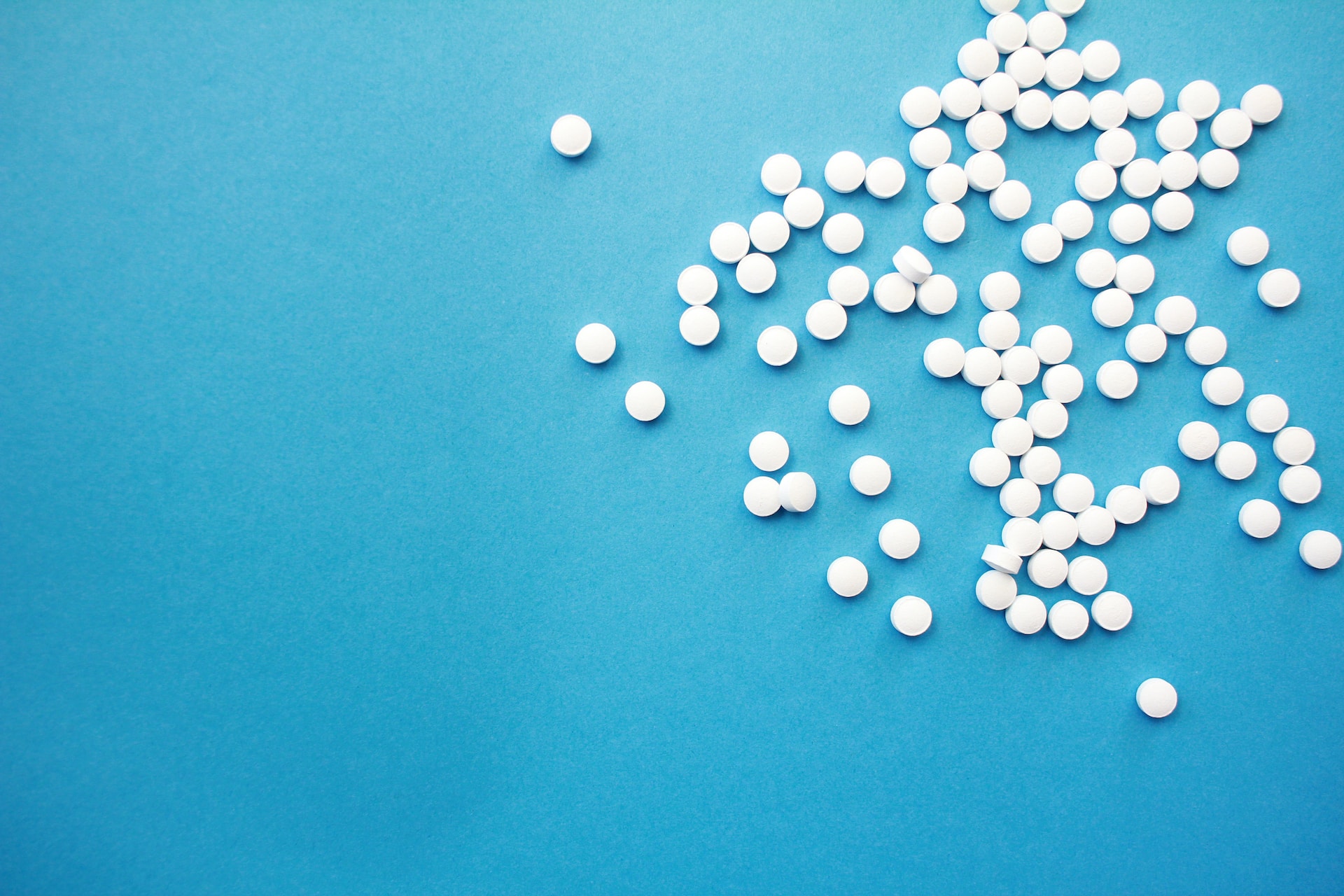 White pills on a blue background