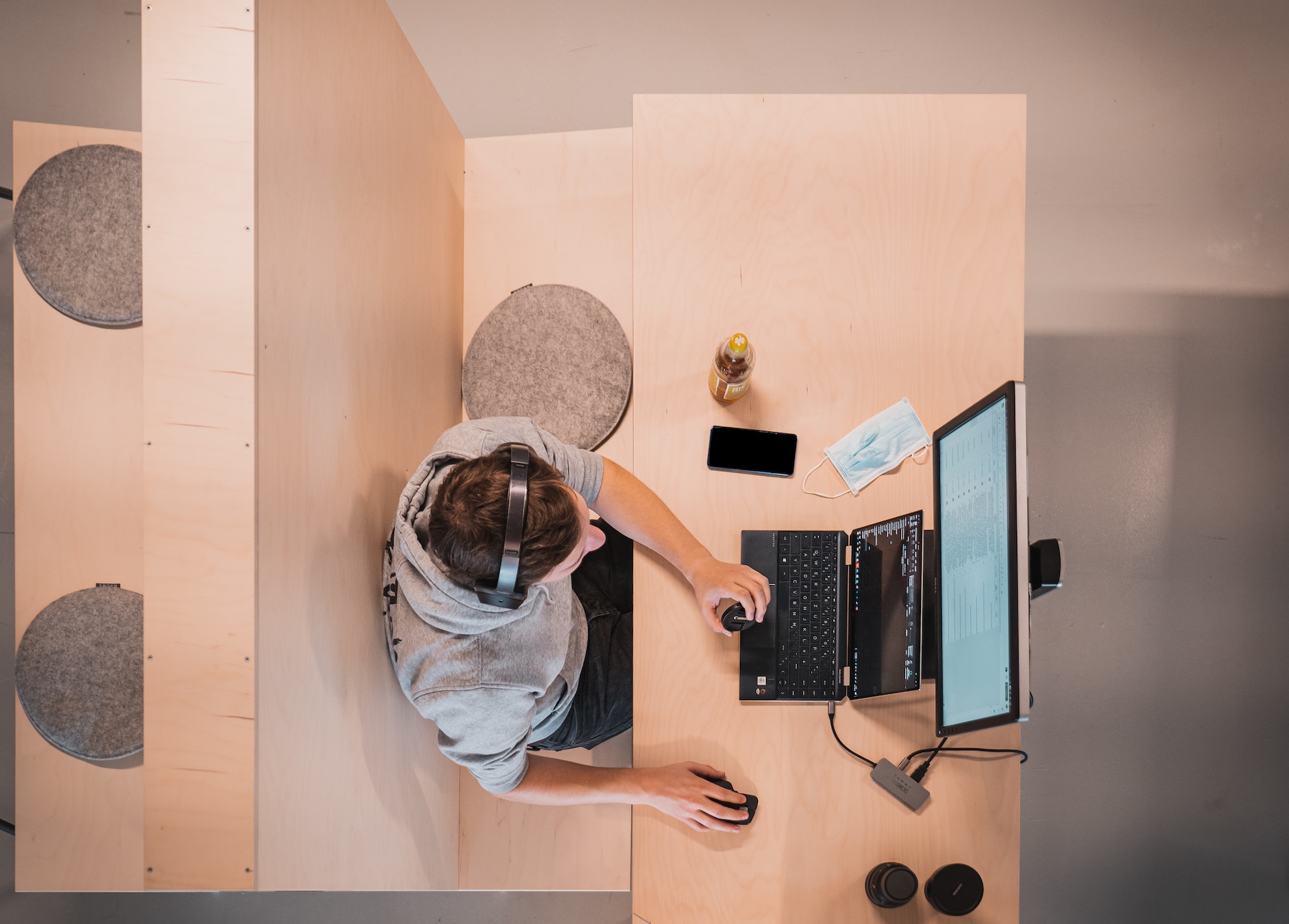 Guy in headphones setting in front of a computer