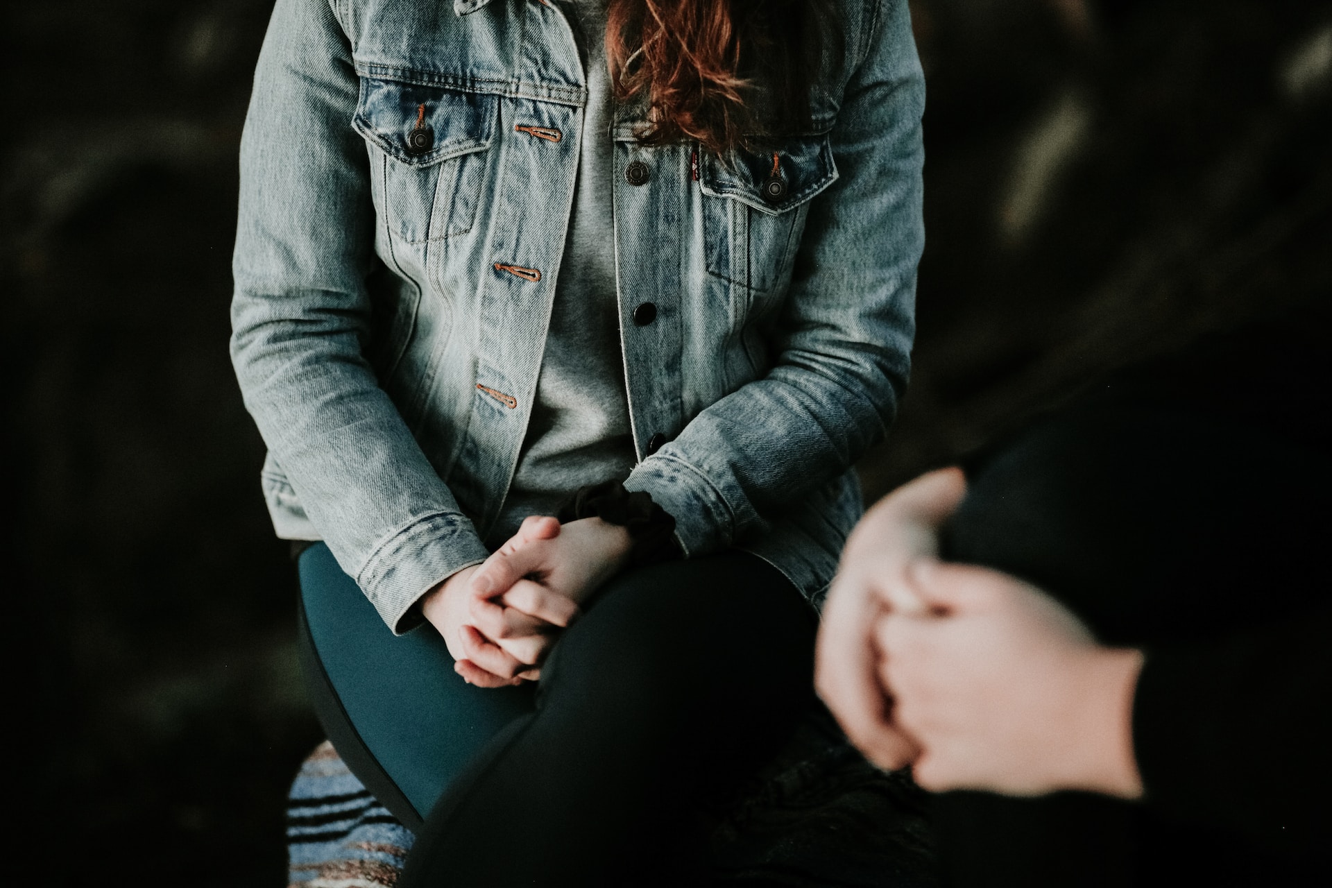 woman with arms crossed over her legs