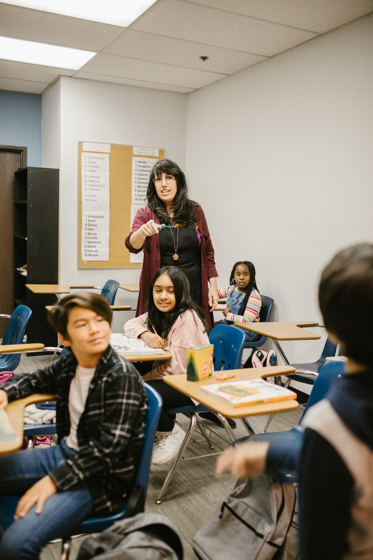 A teacher pointing at a student, calling on him