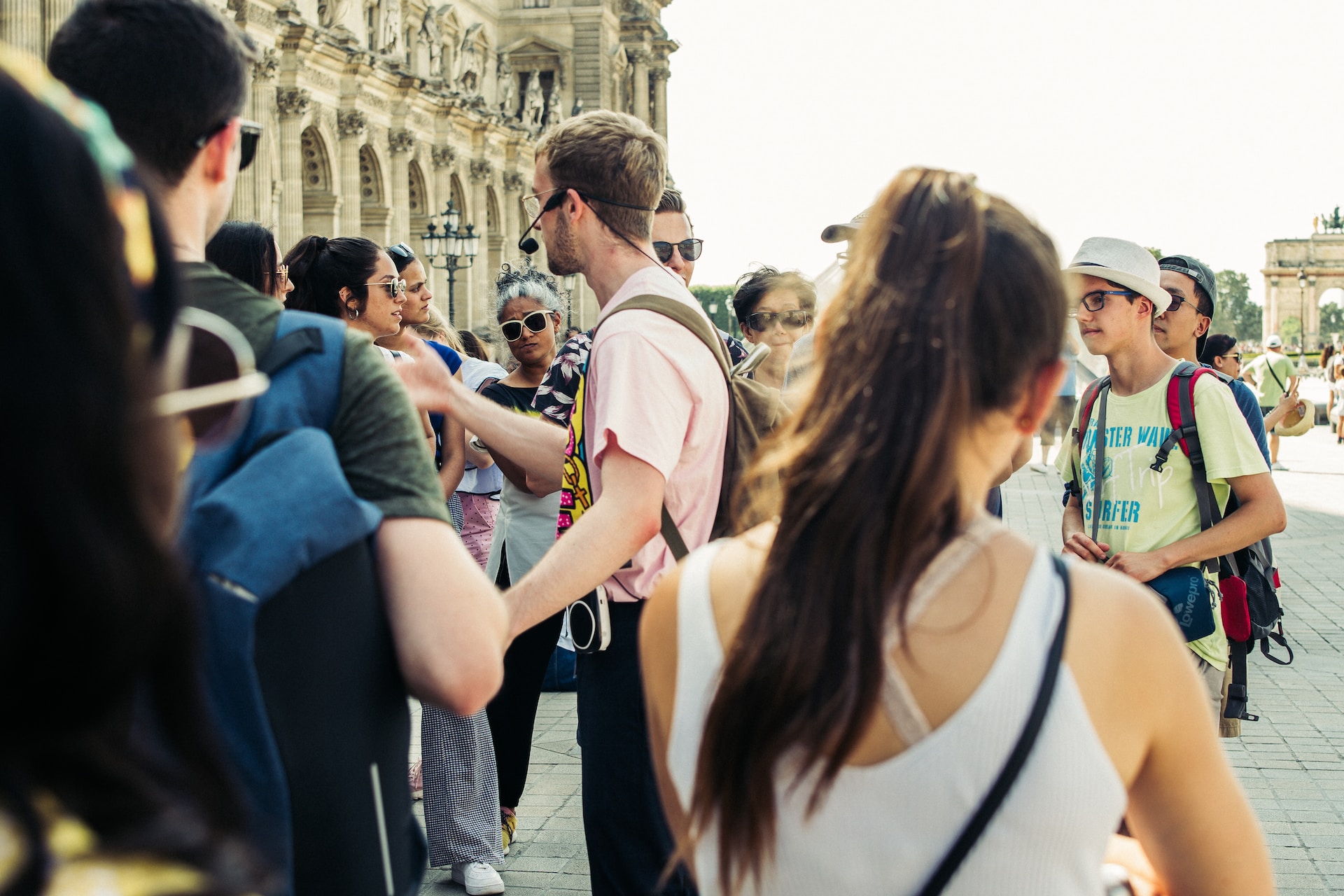 Shows people surrounding a man mic'd up