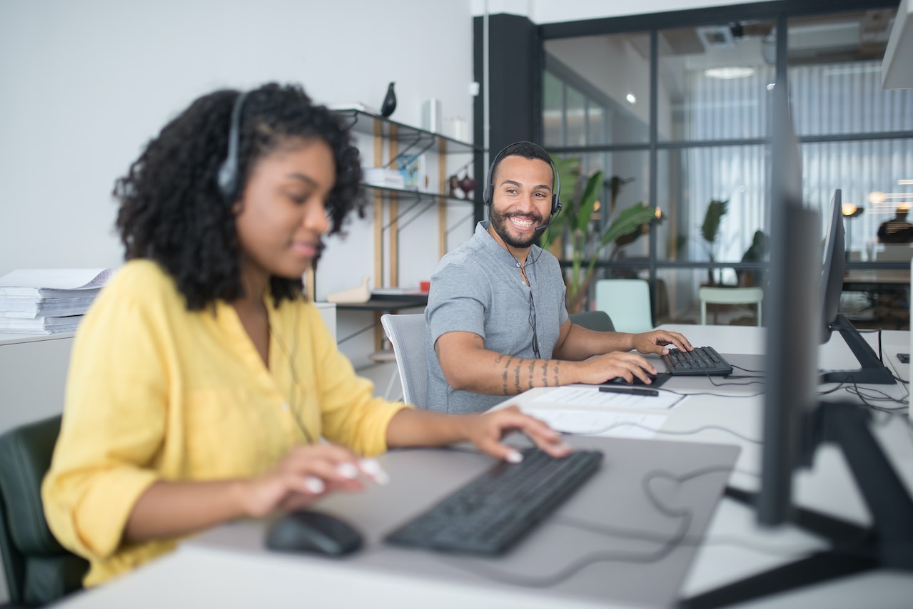 A Man and a Woman Working in Call Center