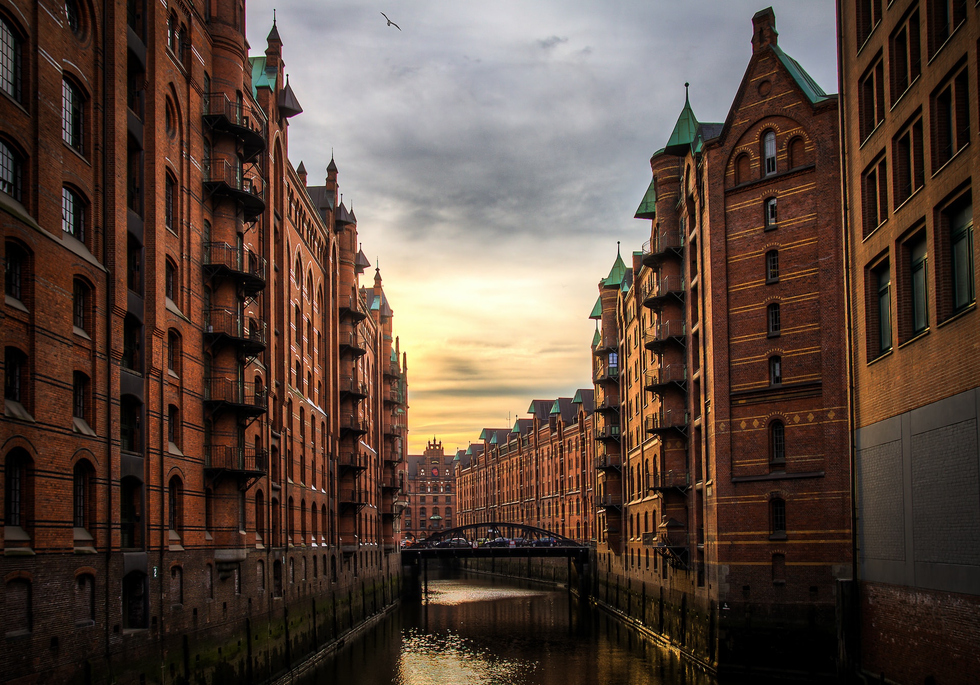 river between brown brick buildings