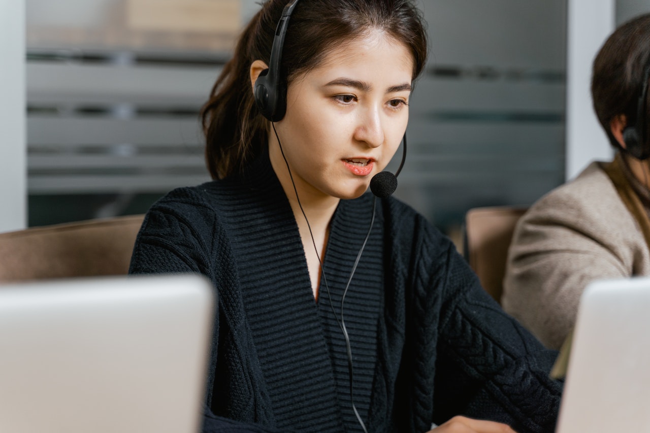 Woman Wearing Black Headset While Working
