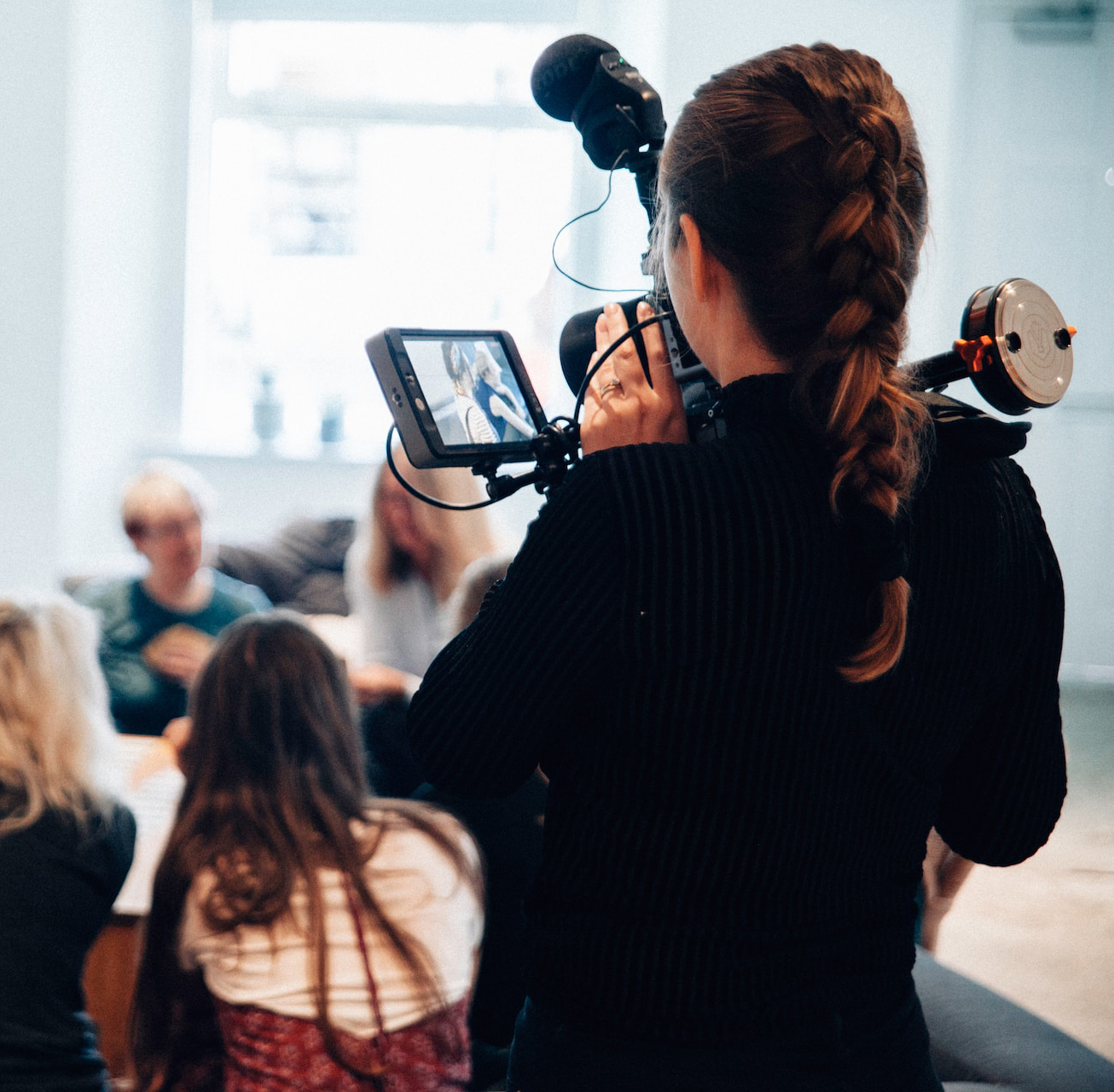 Woman filming other women talking