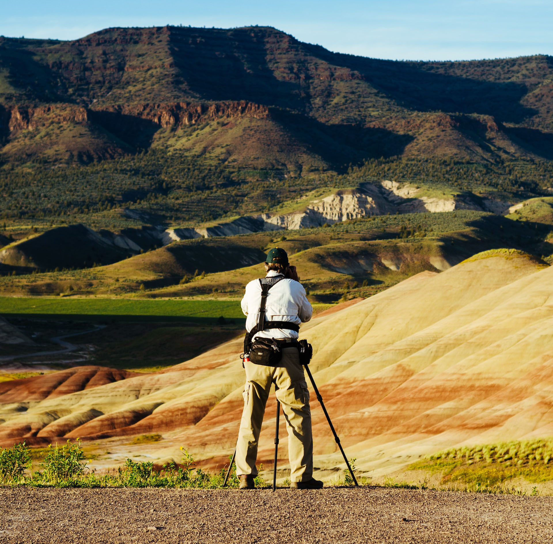 Guy taking a picture of a rock formation