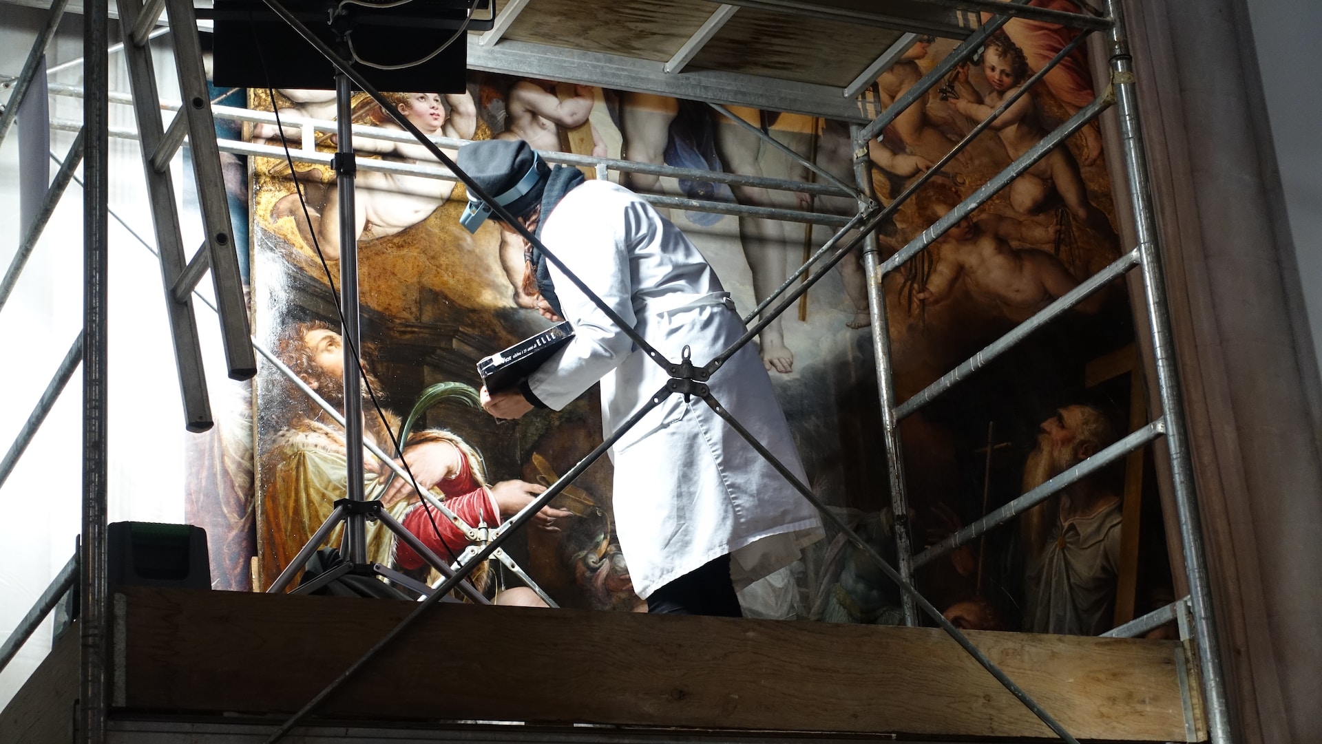 Restorer working on a mural