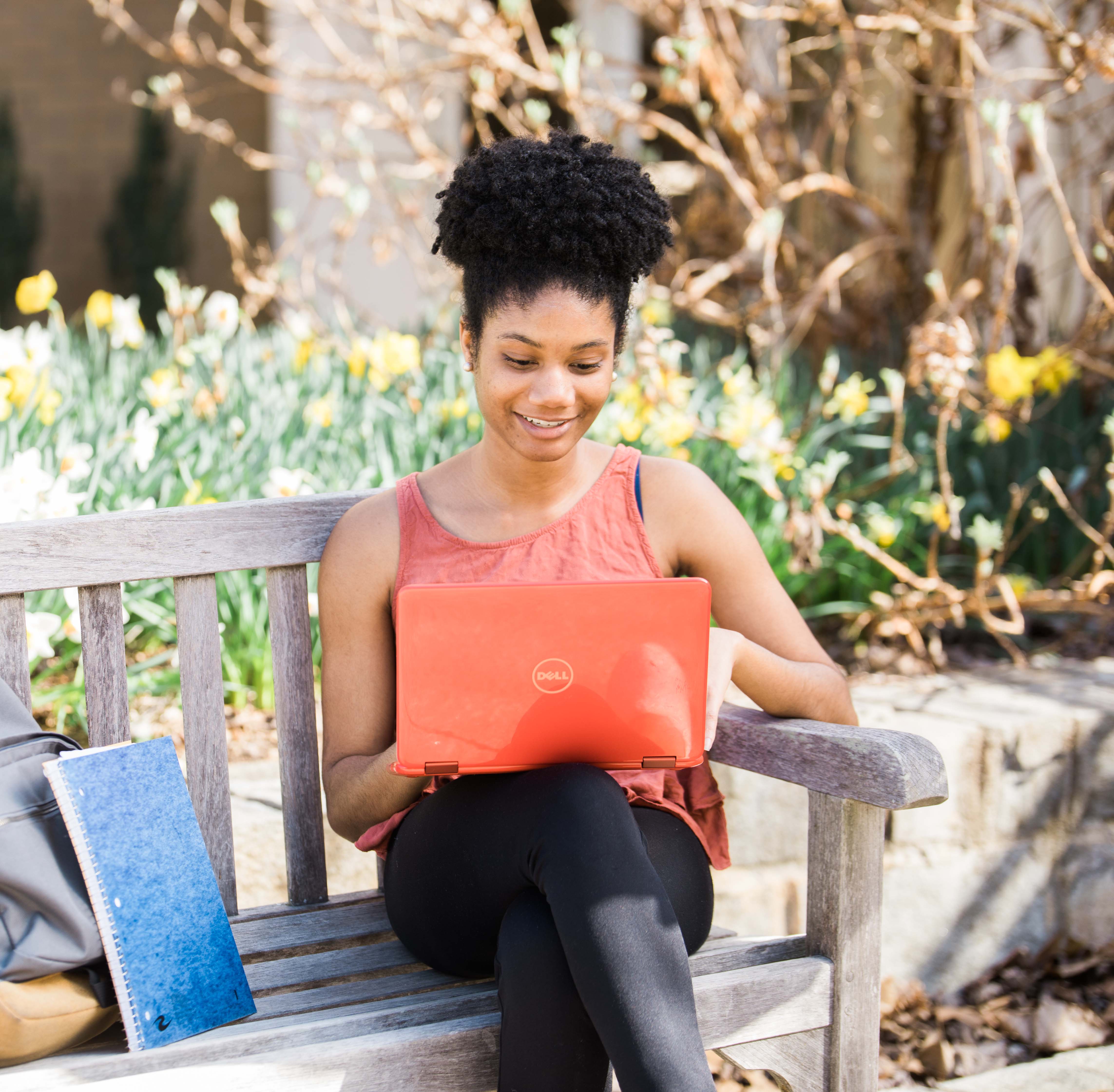 african american female student sitting on a bench