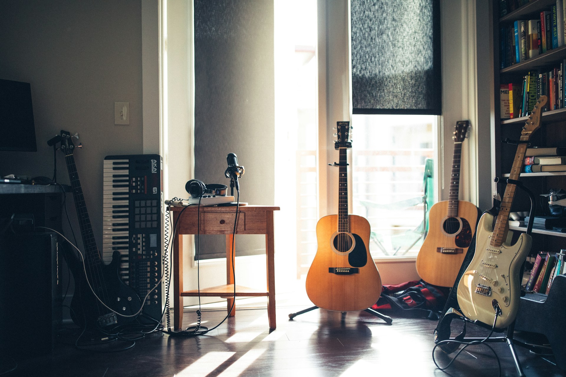 Several guitars beside a side table