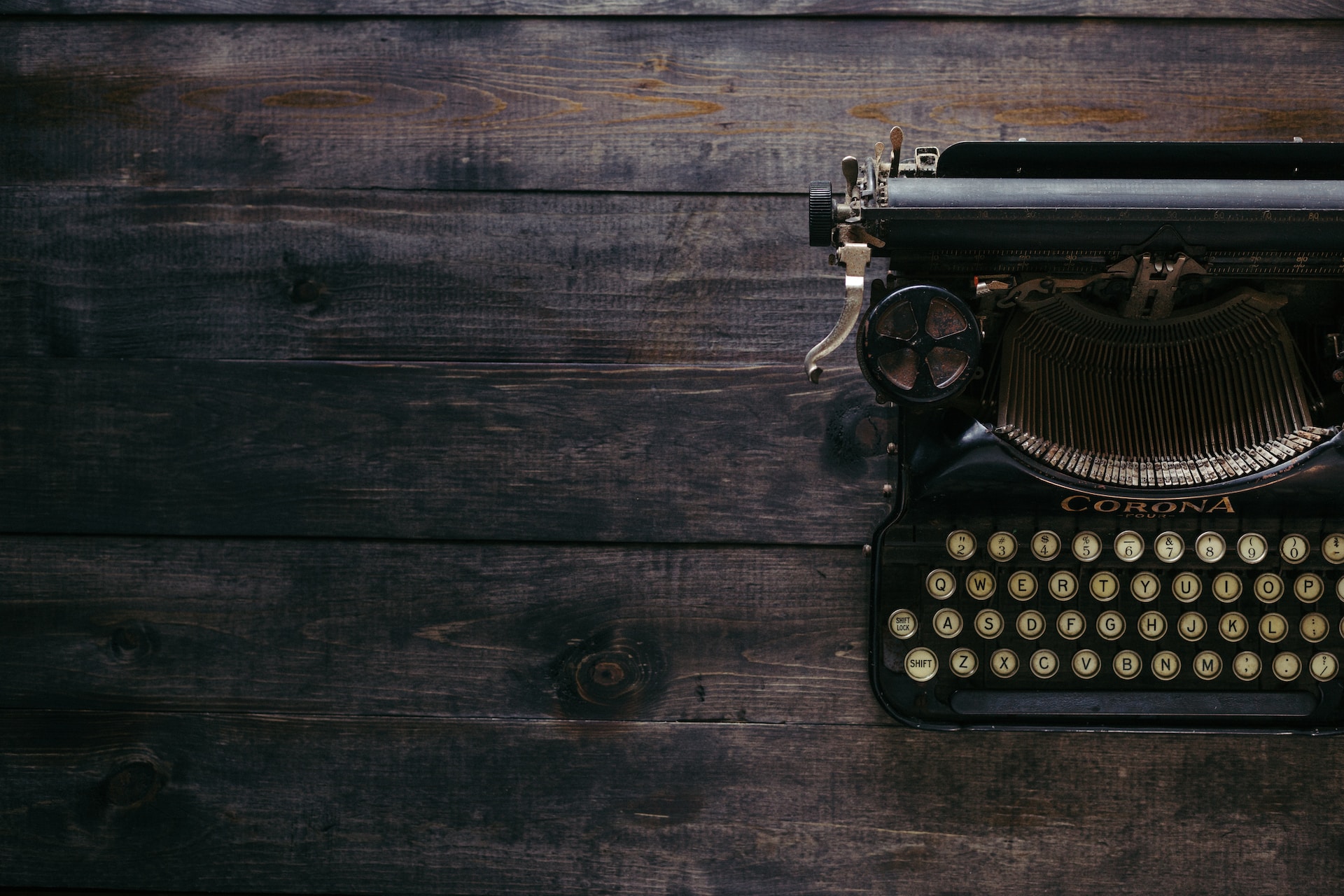 Typewriter sitting on a wooden table