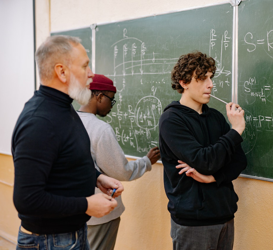 Students working on math problems with their professor