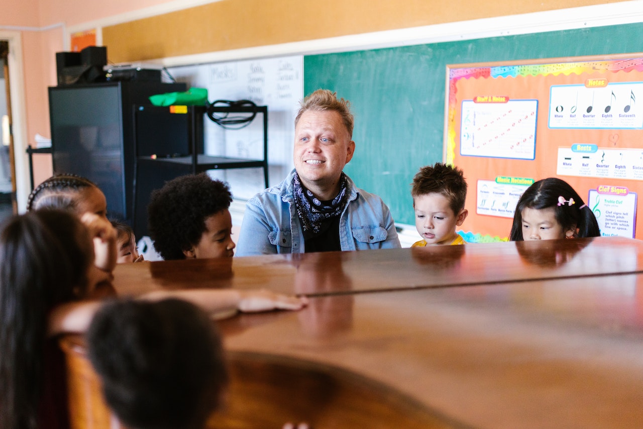 Music teacher sitting at a piano