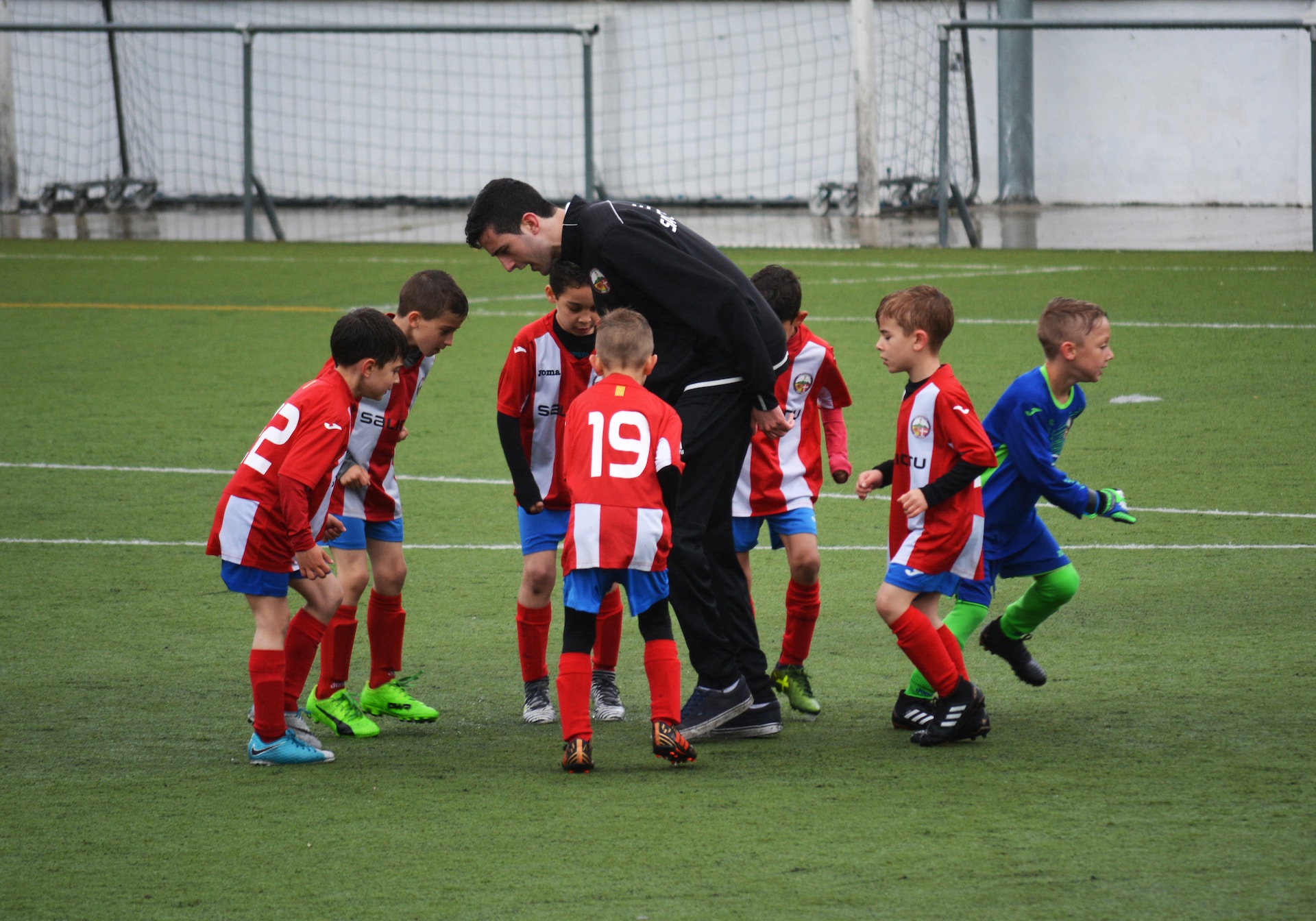 Man coaching a little league soccer team