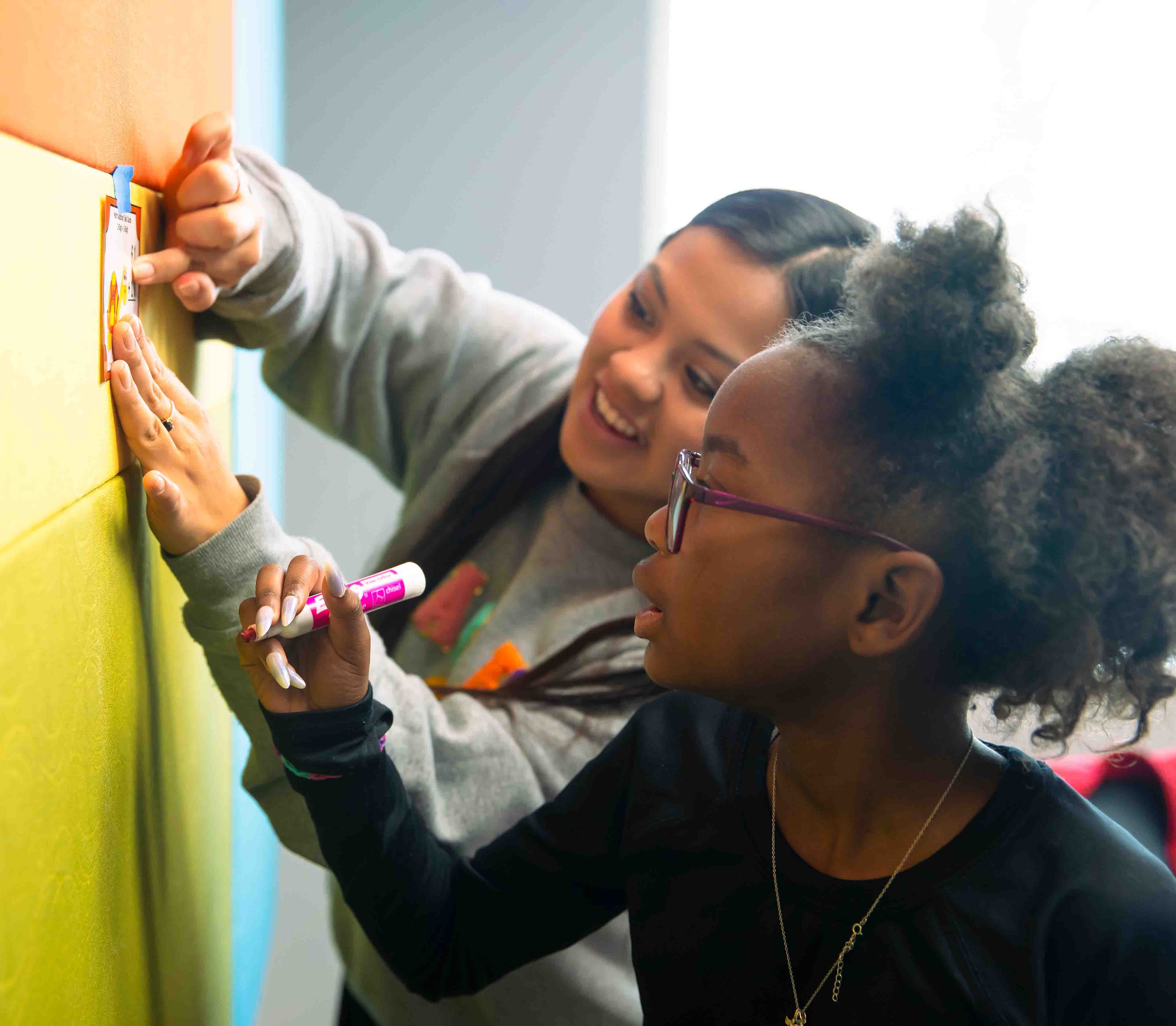 A college student helping a child