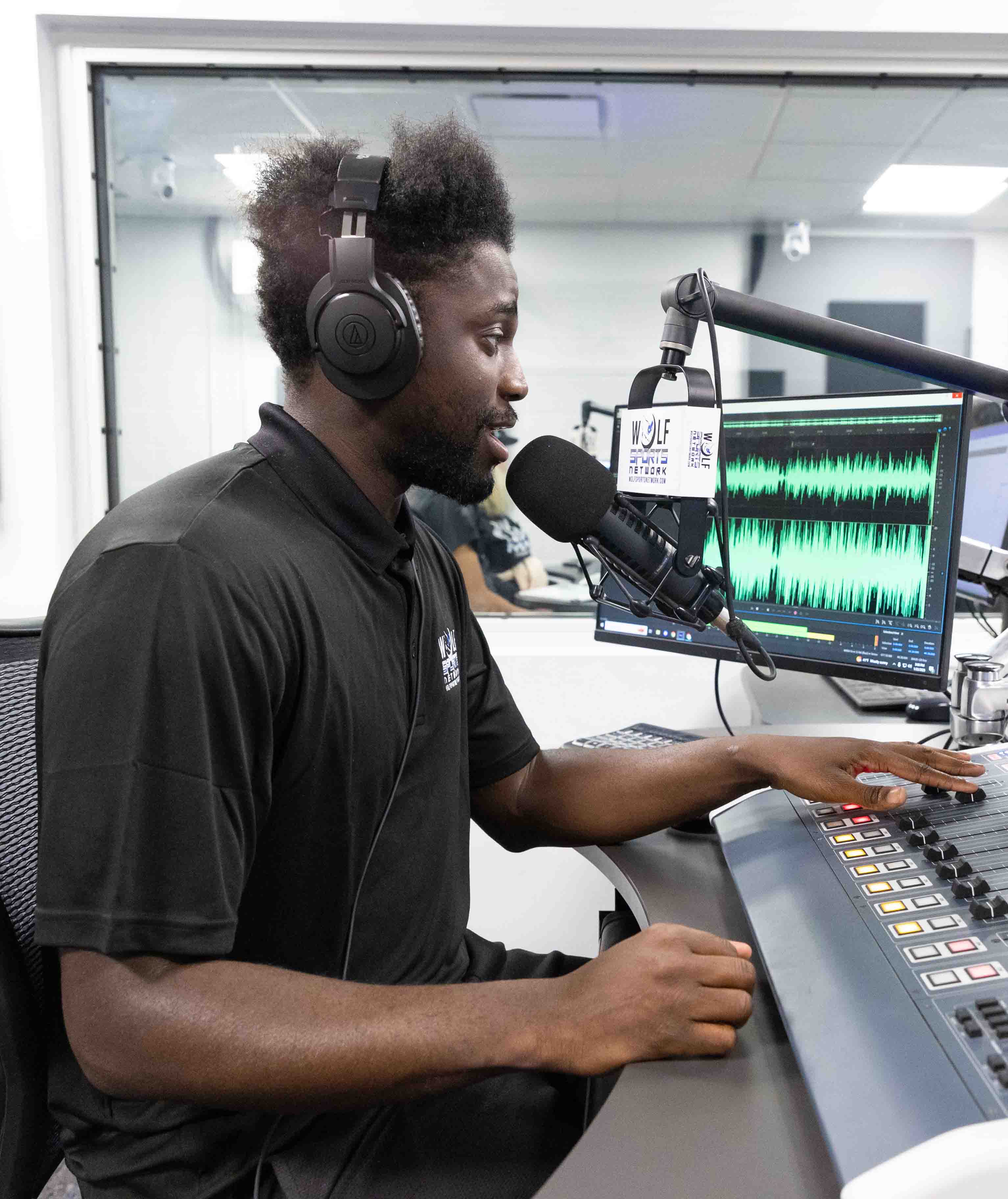Student working at WOLF Radio
