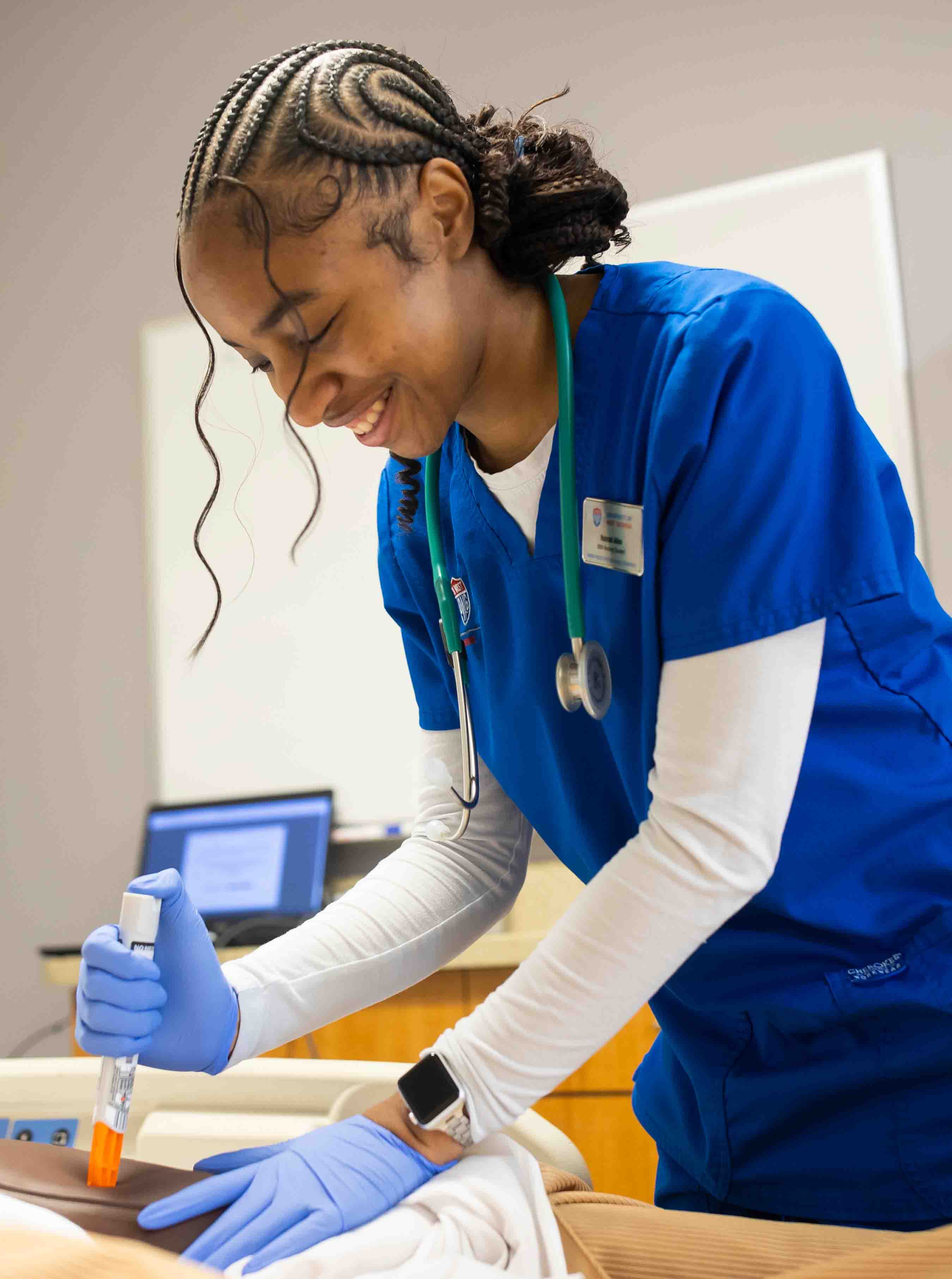 Student practicing giving a shot