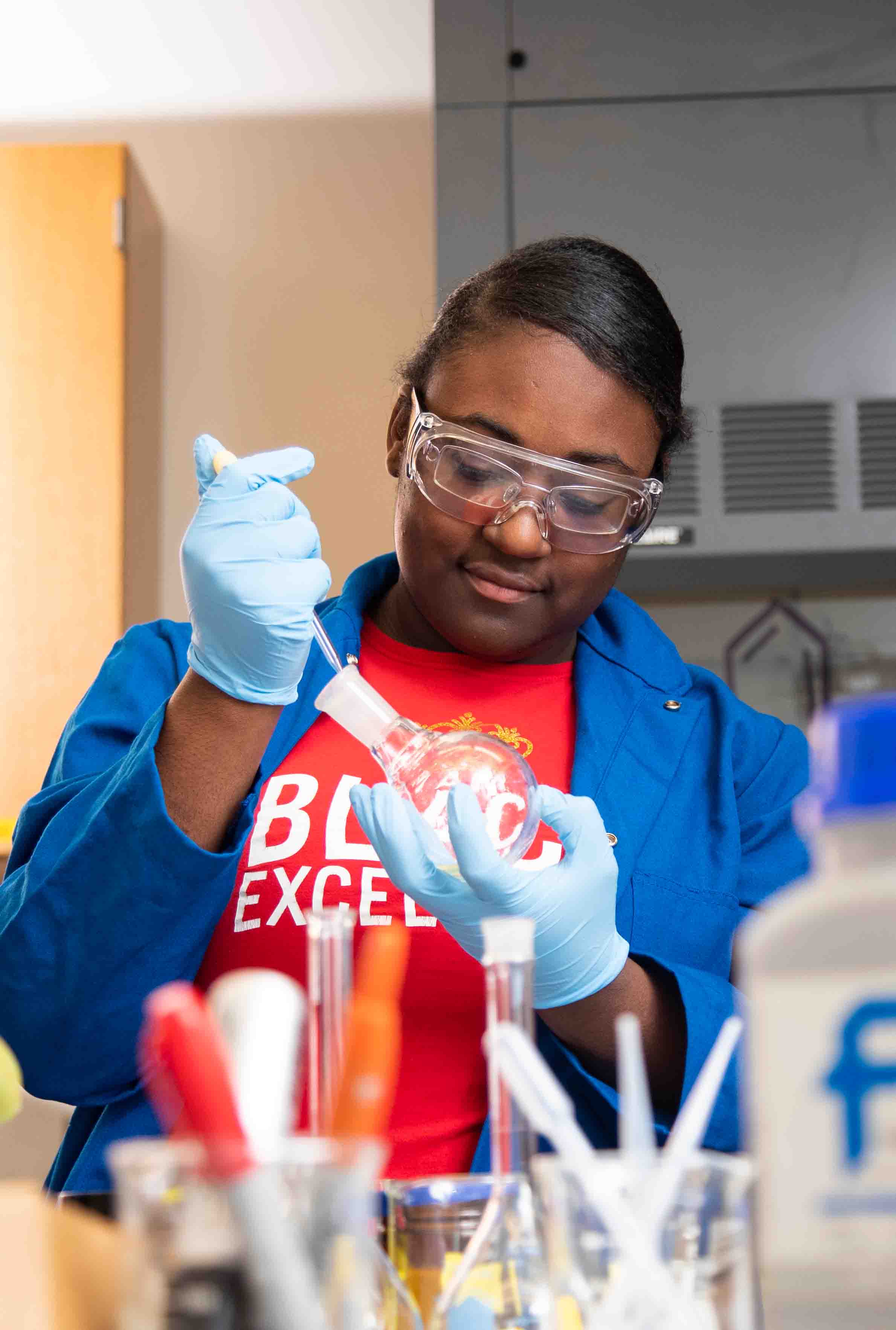 A student holding a petri dish