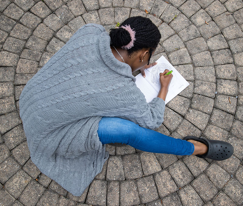 overhead view of student drawing outside