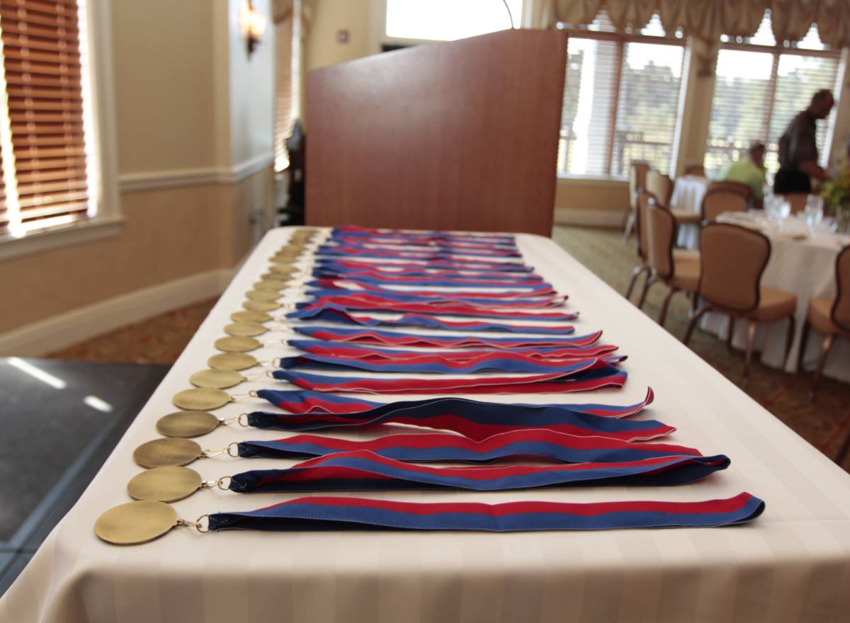 Several medals on a table waiting to be given to their award recipient 