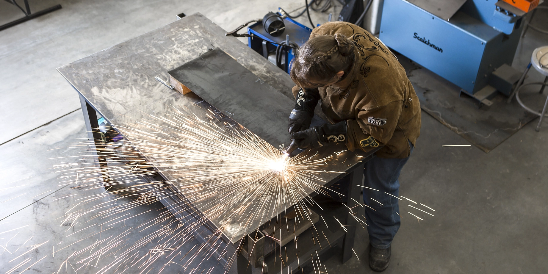 student welding with sparks flying