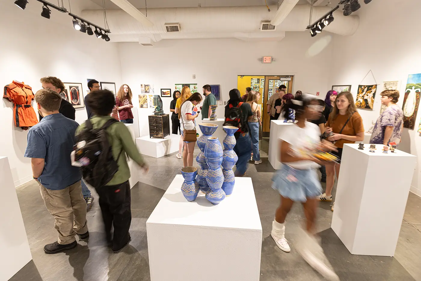Student smiling in art gallery.