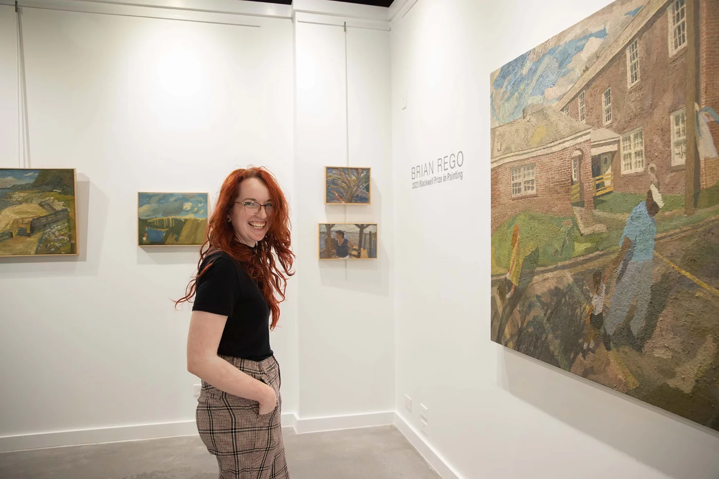 Student smiling in art gallery.