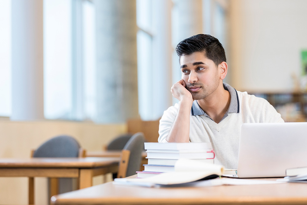 Man thinking pensively at a computer