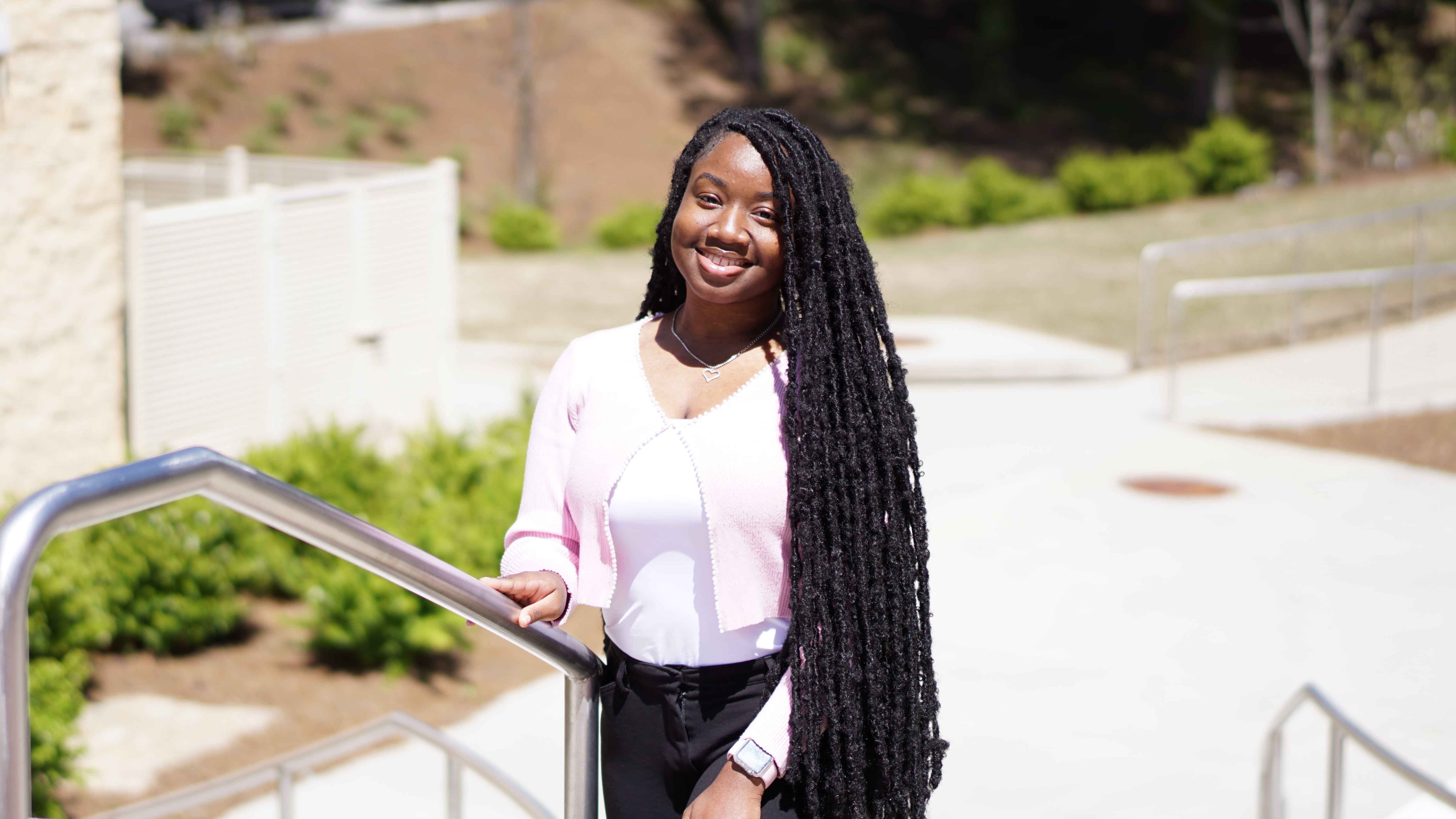 Student standing on steps outside of RCOB.