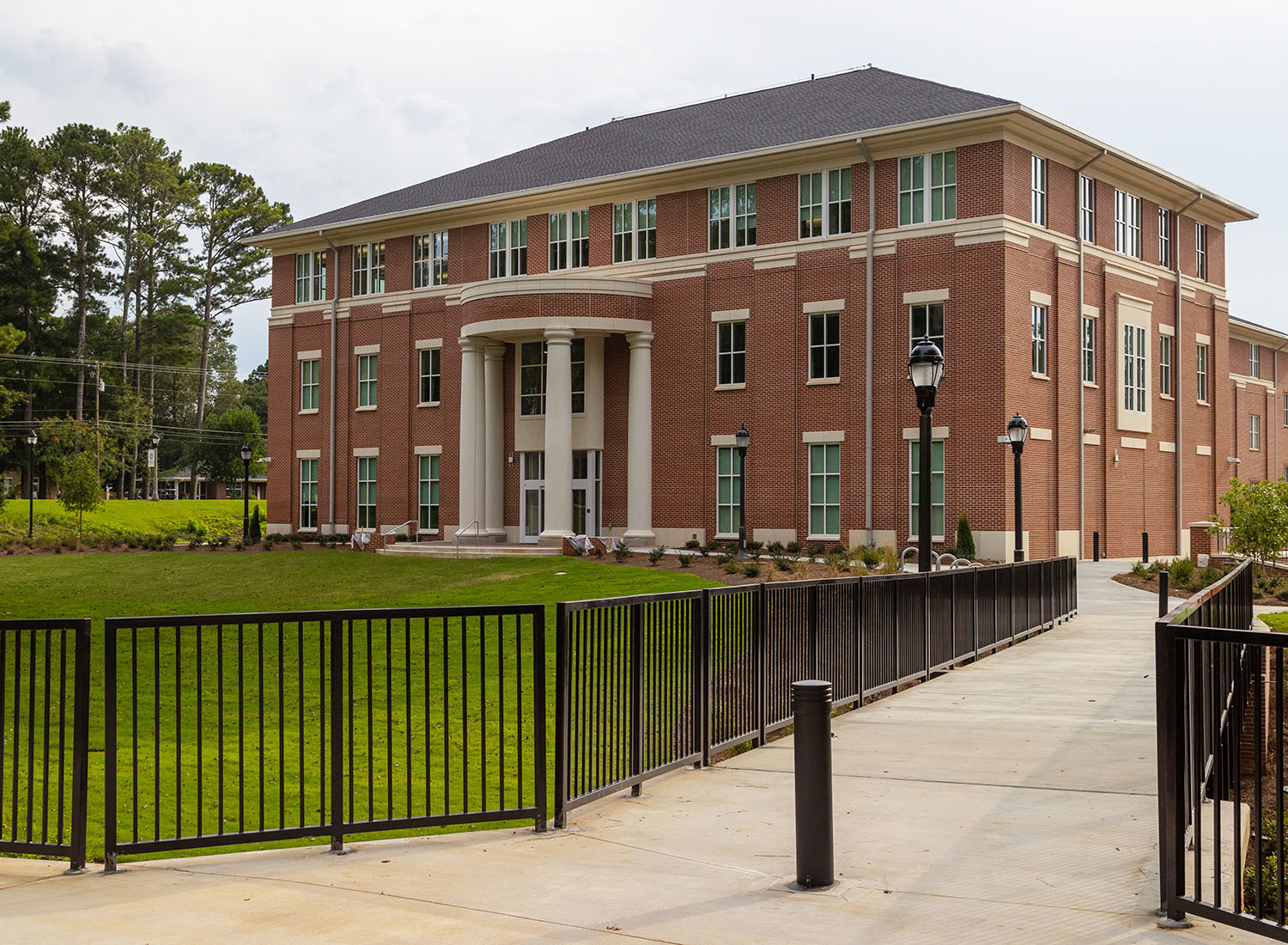 Roy Richards Sr Hall with walking pedestrian bridge and green space surrounding.