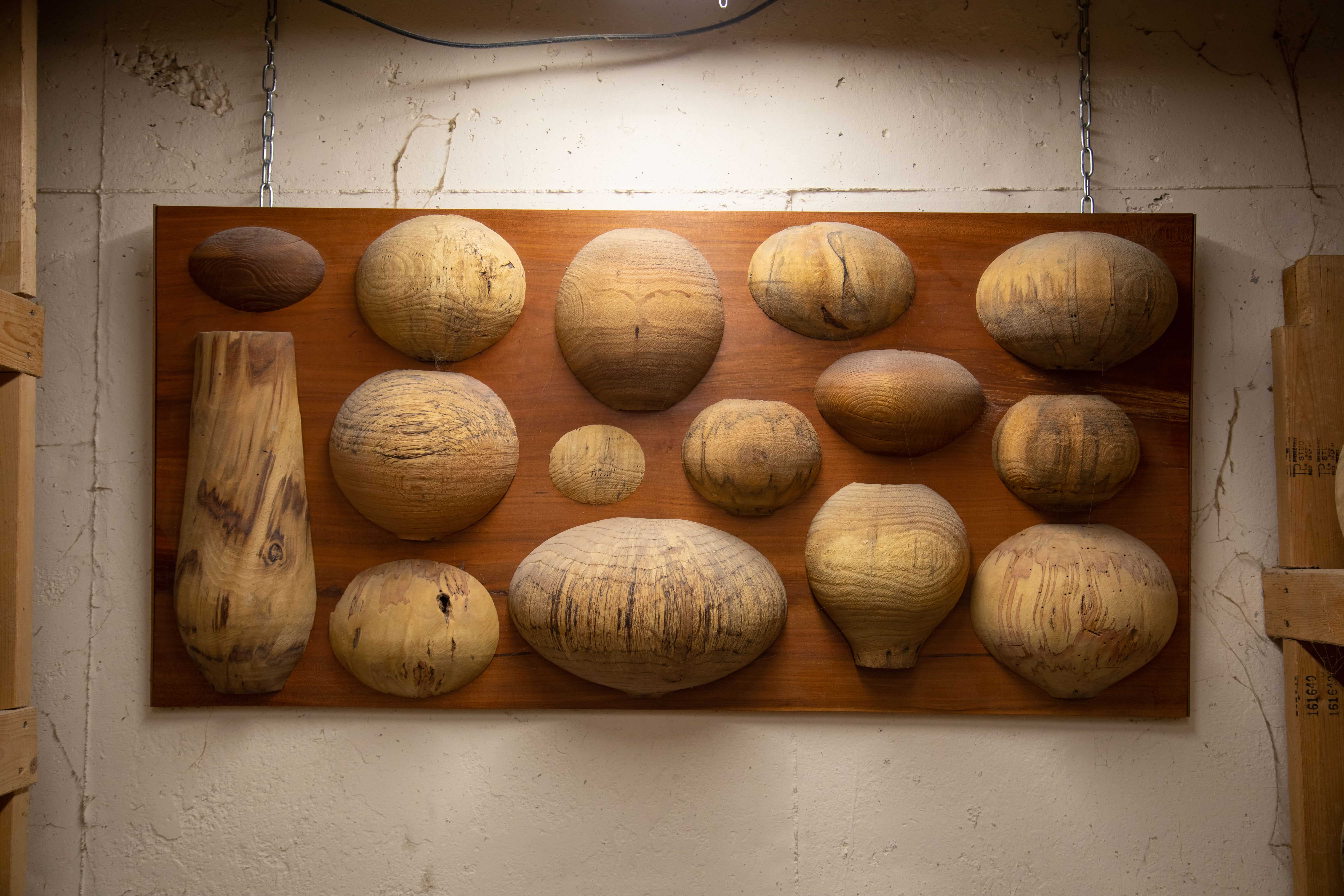 Philip Moultrop's wood bowl collage art hanging on a wall.