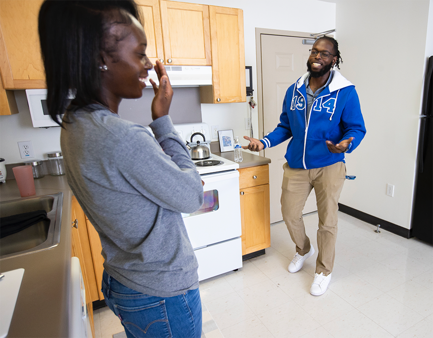 students talking in kitchen