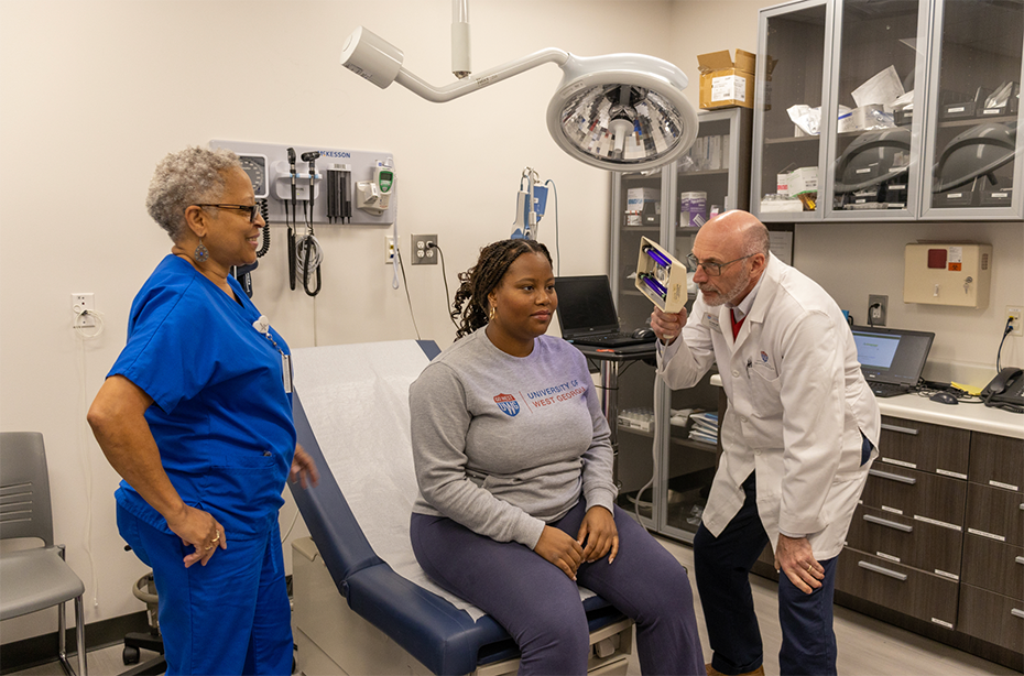 Dr. Heine helping a student at the health center