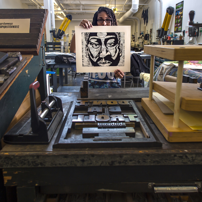 Printmaking student showcasing one of her relief prints