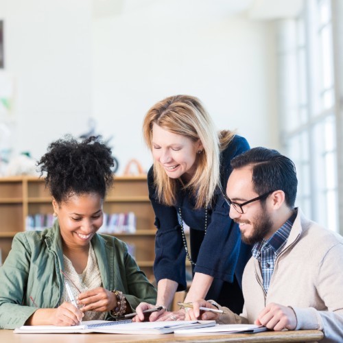students receiving assistance from a teacher