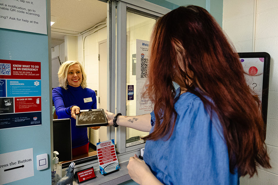 student getting help at front window of counseling center