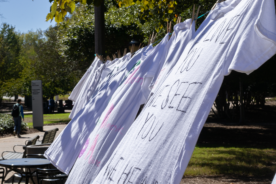 Students holding a wolves walk for sexual assault awareness banner