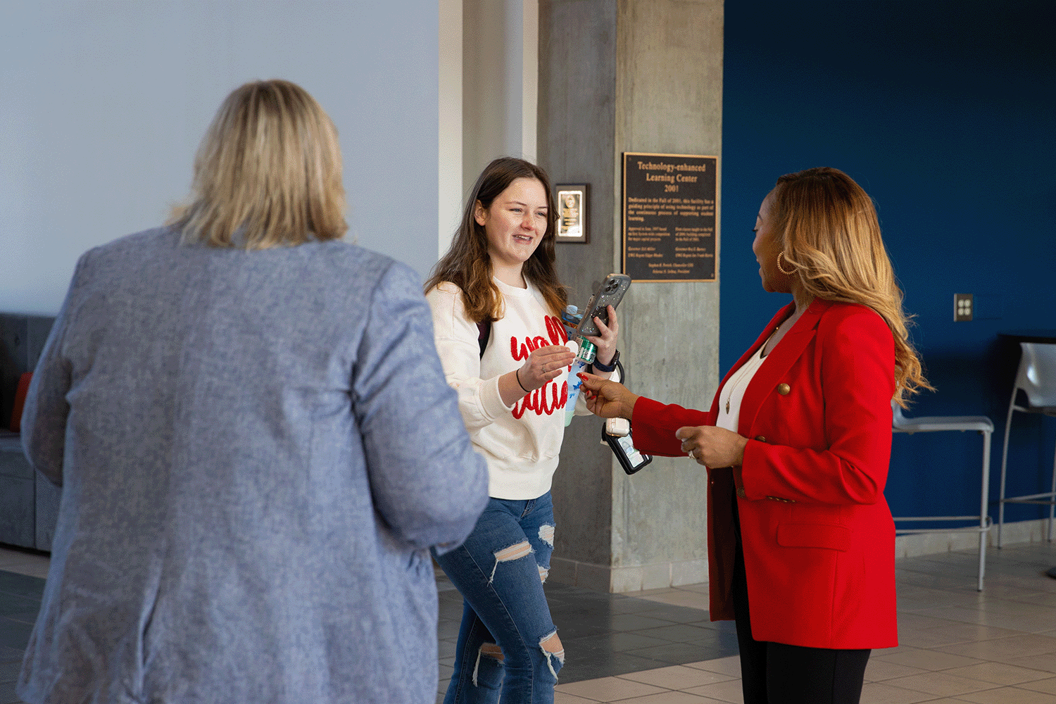 Dr. Rawlinson and staff handing out stickers to students