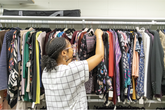 Student picking clothes out of Career Closet